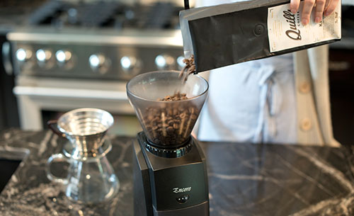 An image of ​Baratza Encore burr grinder with coffee beans