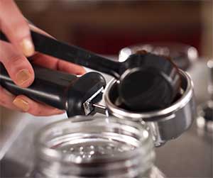 An image of KitchenAid Pro Line Series' portafilter with coffee grounds  
