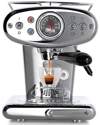 Front of the Francis Francis X1 Iperespresso with coffee dripping from its spout into a glass cup 