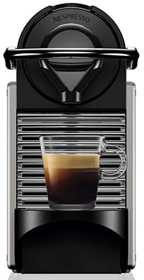 Black Nespresso Pixie Machine with a cup of coffee under its spout