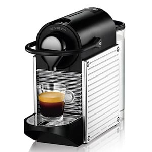 Nespresso Pixie C60 in silver case with a cup of coffee under its spout