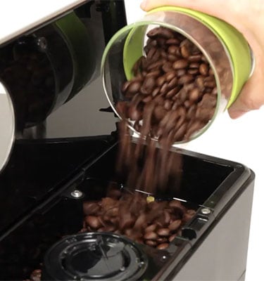 Beans being poured into the bean hopper of Gaggia Anima Coffee and Espresso Machine